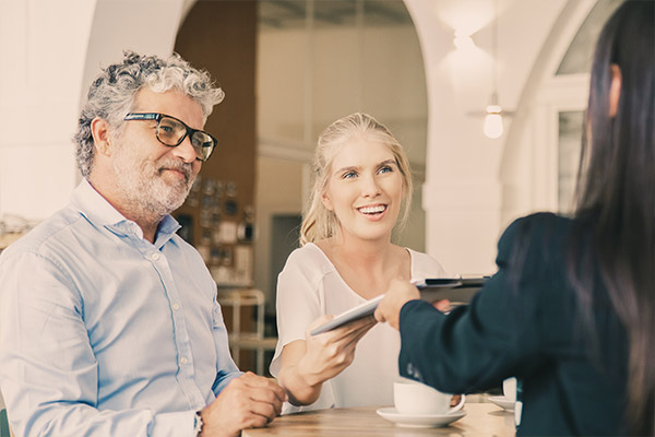 Couple meeting with a woman about additional personal insurance coverages