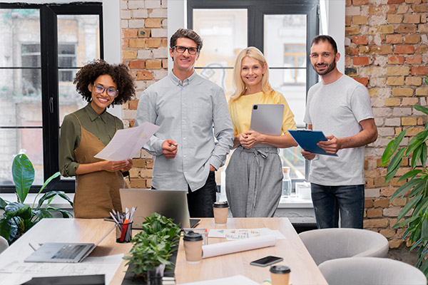 Co-workers in an office who are pleased with their employee benefits