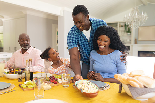 Family in a kitchen that has life insurance coverage