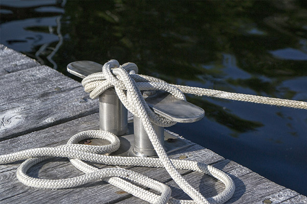 Rope tied to a dock cleat and a vessel that has watercraft insurance